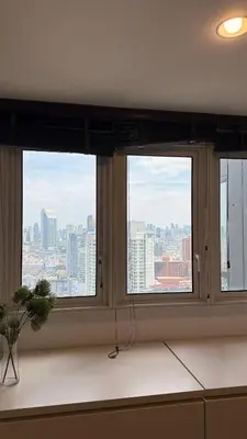 two windows in a room with a view of a city at Lovely home 2 in Ban Na Song