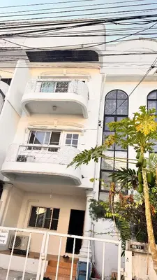 a white house with a tree in front of it at Bangkok villa with 3 bedrooms in Ban Zong Katiam