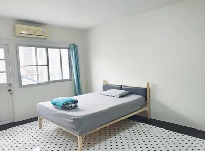 a bed in a room with a window at Bangkok villa with 3 bedrooms in Ban Zong Katiam