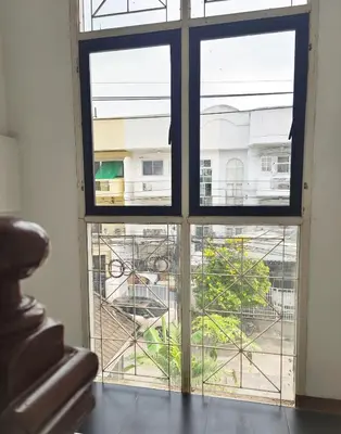 a window in a room with a view of a building at Bangkok villa with 3 bedrooms in Ban Zong Katiam