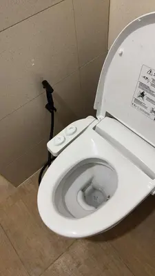 a white toilet with the seat up in a bathroom at Bangkok villa with 3 bedrooms in Ban Zong Katiam