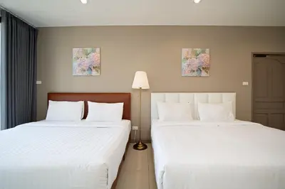 two beds sitting next to each other in a room at Grand 3BR Townhouse in the Heart of BKK - Emsphere in Khlong Toei