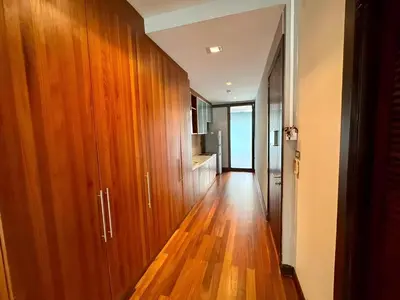 a hallway with wooden cabinets and a hard wood floor at Wish Inn Silom - Decho Bangkok City in Bang Rak