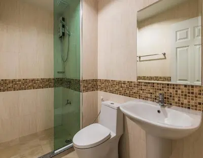 a bathroom with a toilet and a sink and a shower at BB Garden Resort in Bangkok