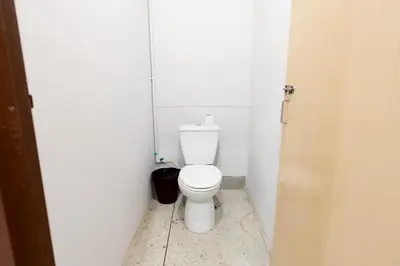 a bathroom with a white toilet in a stall at xx Mitr inn Khaosan ถนนตะนาว in Bangkok