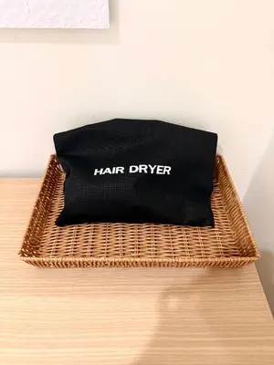 a black bag sitting on top of a wicker table at 166 Living in Bangkok