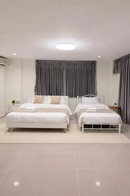 a bedroom with three beds in a room at 166 Living in Bangkok