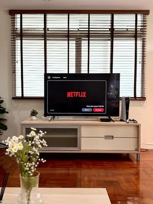 a flat screen tv sitting on top of a entertainment center at 166 Living in Bangkok