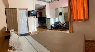 a bedroom with a bed and a living room at Private Apartment in city center and near BTS in Bangkok