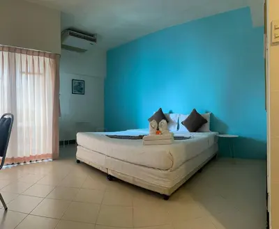 a bedroom with a large bed with a blue wall at Private Apartment in city center and near BTS in Bangkok
