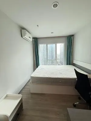 a bedroom with a bed and a large window at Bangson Monthly rental apartment in Bang Su