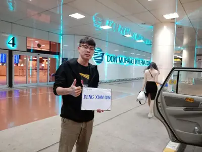a man is holding a sign in a mall at Asia Don Mueang Bangkok Condominium in Nonthaburi