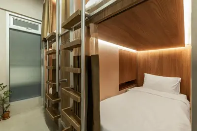 a small bedroom with a bed and a bunk bedewayeway house at The District Hostel Ekkamai in Sathani Khlong Tan