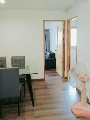 a living room with a table and a fan at Boontharika Place Cozy Room Popular Condo near IMPACT Muangthong in Thung Si Kan