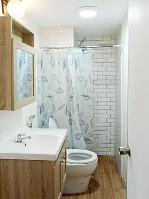 a bathroom with a sink and a toilet and a shower curtain at Boontharika Place Cozy Room Popular Condo near IMPACT Muangthong in Thung Si Kan