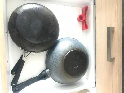 a pan hanging on a wall with a red ribbon at Walking distance to Sukhumvit soi 11 Netflix 40sqm in Makkasan