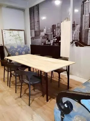 a table and chairs in a room with a city at XX GO INN Silom - Bangrak BTS St Louis in Yan Nawa