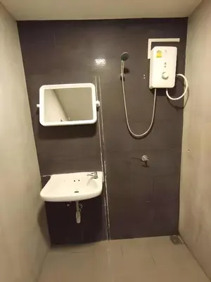 a bathroom with a sink and a mirror at GO INN Silom - BTS St Louis Bangkok in Yan Nawa