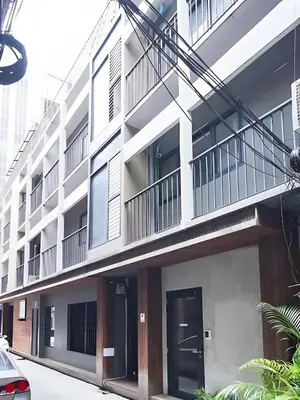 an external view of a building with a door at GO INN Silom - BTS St Louis Bangkok in Yan Nawa