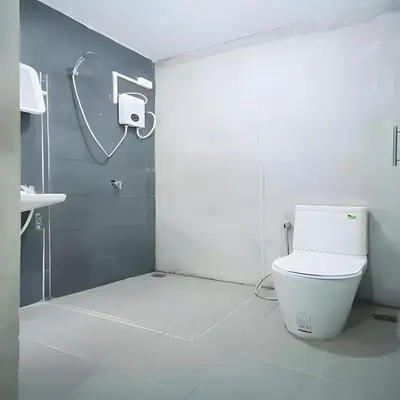 a bathroom with a toilet and a shower stall at GO INN Silom - BTS St Louis Bangkok in Yan Nawa