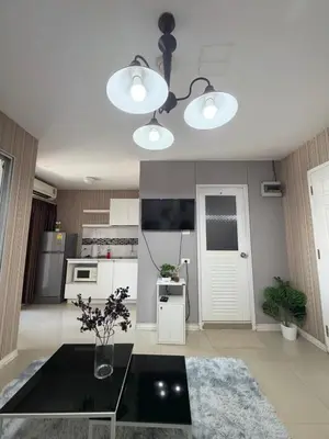 a living room with a table and two lights at Stadium Area Stay Famous Thai Street Food in Bangkok