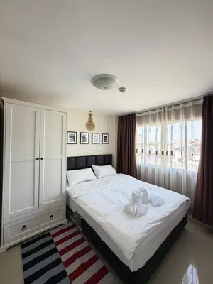 a bedroom with a large bed and a white cabinet at Stadium Area Stay Famous Thai Street Food in Bangkok