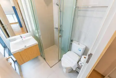 a bathroom with a shower and a toilet and a sink at Heaven Sukhumvit 62Villa in Bangkok