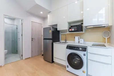 a kitchen with a washing machine and a refrigerator at Heaven Sukhumvit 62Villa in Bangkok
