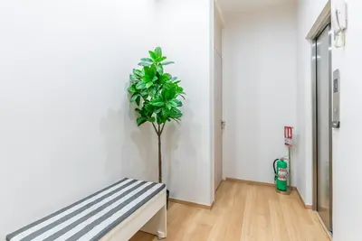 a plant in the corner of a room with a bench at Heaven Sukhumvit 62Villa in Bangkok