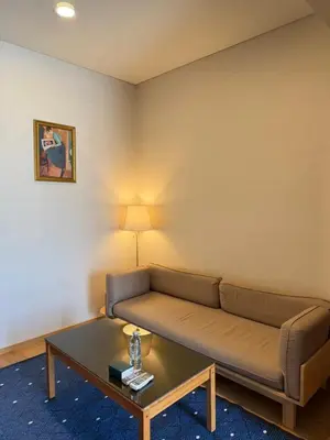 a living room with a couch and a coffee table at Sky Luxury Near BTS Ekkamai pool gym Netflix in Khlong Toei