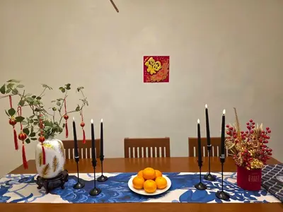 a table with a plate of oranges and candles on it at Baan Surawong 390 Heritag house in Chinatown