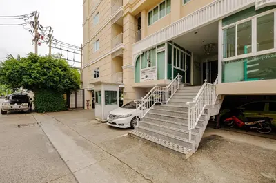 a white car parked outside of a building at 1 BR 5 Mins BTS Bearing 7-11 and Lotus in Ban Khlong Samrong