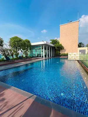 a swimming pool in front of a building at Luxury Apt BTS EKKAMAI with pool sauna gym in Bangkok