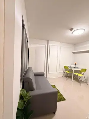 a living room with a couch and a table at Best Value Condo Lumpini Rajamangala in Sathani Khlong Tan