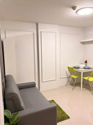 a living room with a couch and a table at Best Value Condo Lumpini Rajamangala in Sathani Khlong Tan