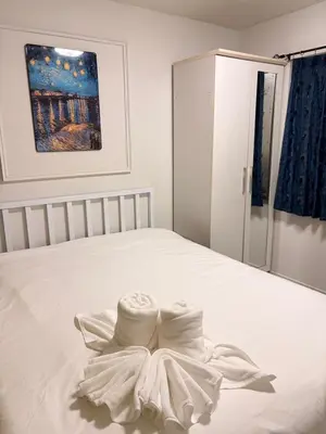 a white bed with a dress on it at Best Value Condo Lumpini Rajamangala in Sathani Khlong Tan