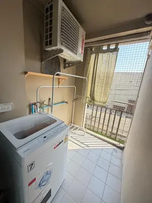 a kitchen with a sink and a microwave and a window at Best Value Condo Lumpini Rajamangala in Sathani Khlong Tan