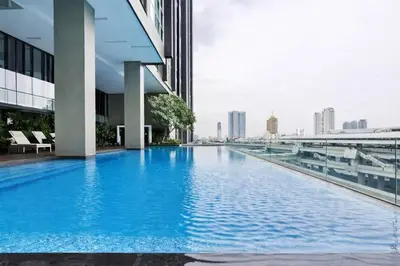 a swimming pool on the side of a building at Hive Sathorn SkyCorner Suite, BTS and 7-11 front in Bangkok