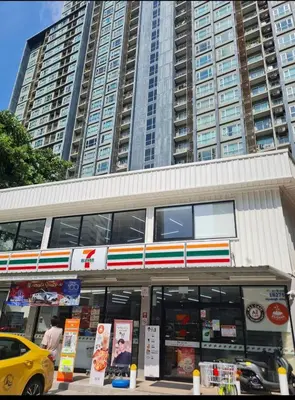 a store with a yellow car parked in front of it at Hive Sathorn SkyCorner Suite, BTS and 7-11 front in Bangkok