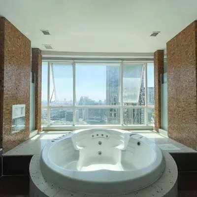 a large bath tub in a room with a large window at Lucky 808 2BedRoom 100sqm BTS Chidlom in Bangkok