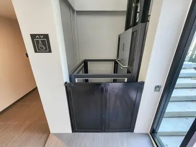 a stairway with a black door in a room at Quiet apartment with pool close to MRT station in Bangna