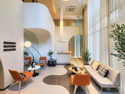 a lobby with a couch and chairs and a table at Quiet apartment with pool close to MRT station in Bangna