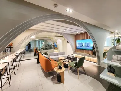a living room with a couch and tables and chairs at Quiet apartment with pool close to MRT station in Bangna