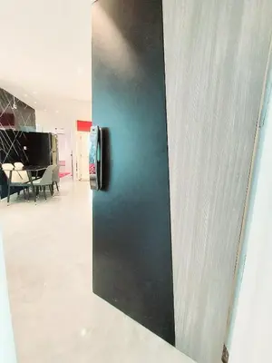a sliding door in a room with a dining room at Charming 2-Bedroom Apartment in ON-NUT, Bangkok in Amphoe Phra Khanong