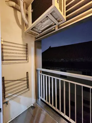 a room with a balcony with a staircase and a piano at Homely Condo Minimal Style Near BTS Silom line in Bang Khun Thian