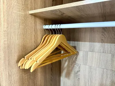 a wooden object is hanging on a wall at 5 Min walk to BTS Onnut Duplex Loft At Sukhumvit in Amphoe Phra Khanong
