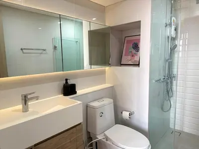 a bathroom with a toilet and a sink and a shower at 5 Min walk to BTS Onnut Duplex Loft At Sukhumvit in Amphoe Phra Khanong
