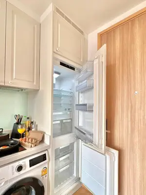 a kitchen with an empty refrigerator in a kitchen at WalkToBTS>EMDistrict/CityViewPool&Gym/WiFi/Washer in Khlong Toei