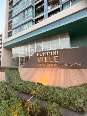 a sign in front of a building with a skateboard ramp at Lumpiniville Sukhumvit in Bangna