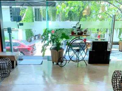 a room with a bike and a table and a plant at Aspira D'Andora Sukhumvit 16 - Asoke in Bangkok
